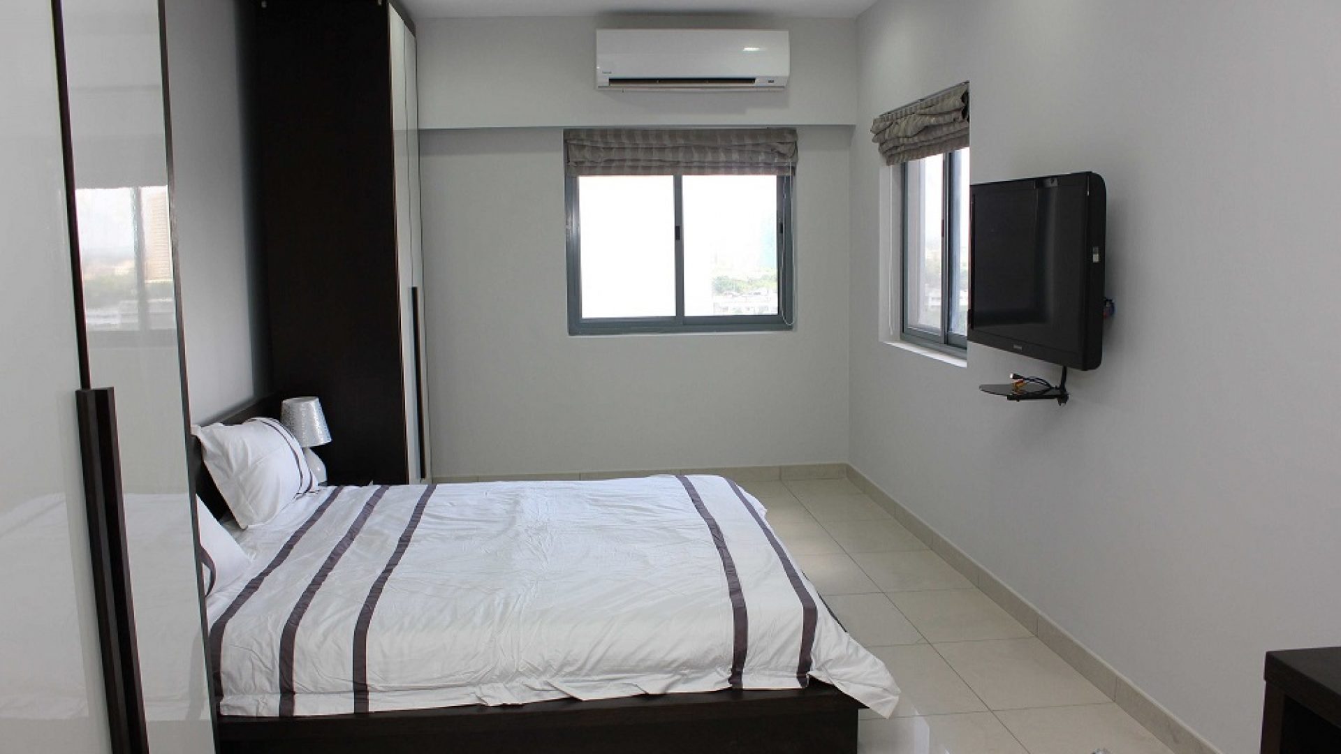 Bedroom with TV of the Two Bedroom Furnished Apartment in Upanga Dar es Salaam by Tanganyika Estate Agents
