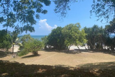 Amboni –  Secluded private beachfront plot  –   small bungalow with ample space for a house